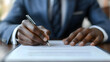 © Siasart Stock - Businessman Signs Contract Agreement Carefully and Precisely with Pen