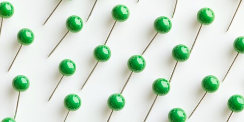 Poster - Green pins arranged on a white background create a vibrant contrast. The green pins stand out prominently against the white background, highlighting their unique features in this composition.