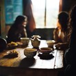 © Elena L - Friends share a warm meal in a cozy, sunlit room, illustrating the comfort and connection of intimate gatherings.