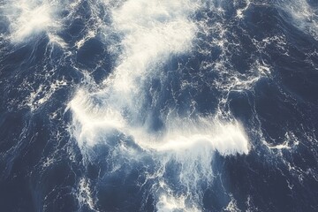 Wall Mural - beautiful aerial view of turbulent ocean waves with white foam creating dynamic patterns in deep blu