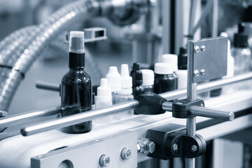 Poster - pharmaceutical industry, medicine pills are filling in the  bottle on production line machine conveyor at the medical factory. selective focus.