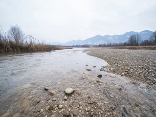 Wall Mural - tranquil river flows through rocky landscape with mountains