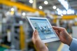 © Віталій Б. - Exploring advanced technology in a modern industrial setting with a digital tablet