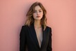 © Fightstar - Young woman in fitted black blazer posing confidently against pastel background