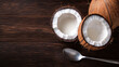 © NAD SANG PAP - Halved coconut shells with milk inside on wooden table, ready to enjoy