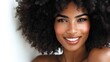 © Fidan - Woman with soft natural curls and smooth skin smiling