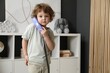 © New Africa - Cute little boy with telephone handset indoors, space for text