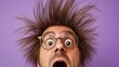 © Konstiantyn Zapylaie - Surprised caucasian male with wild hair and glasses against purple background