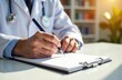 © Nata - male doctor writes on a notepad while working at his workplace in an office in a hospital, concept of health and approach to treatment