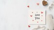 © Yuliia - A handmade Valentine's Day card with the phrase 'I Love You' written in elegant calligraphy, surrounded by small watercolor hearts