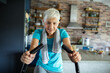 © Marko Geber - Smiling senior woman on fitness bike at home