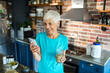 © Marko Geber - Senior woman making healthy organic smoothie in modern kitchen