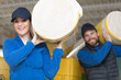 © auremar - caucasian construction workers with roll of insulating material