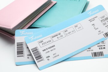 Travel agency. Flight tickets and passports on light background, closeup