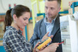 © auremar - female electrician using multimeter under supervision