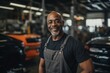 © Baba Images - Smiling portrait of a middle aged African American car mechanic in workshop