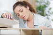 © auremar - woman assembling wooden furniture using screwdrive