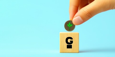 Hand Placing Coin on Block with Green Plant Symbol