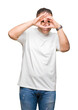© Krakenimages.com - Middle age arab man wearig white t-shirt over isolated background Doing heart shape with hand and fingers smiling looking through sign