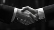 © Chandlerlikes - A close-up of a business hand shaking another, signifying partnership and collaboration in a corporate environment