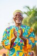 © Ryzhkov - Celebratory Elderly Man in Vibrant Agbada at Festival