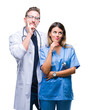 © Krakenimages.com - Young couple of doctor and surgeon over isolated background with hand on chin thinking about question, pensive expression. Smiling with thoughtful face. Doubt concept.