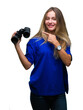 © Krakenimages.com - Young beautiful blonde woman looking through binoculars over isolated background very happy pointing with hand and finger