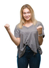 Wall Mural - Young caucasian woman over isolated background celebrating surprised and amazed for success with arms raised and open eyes. Winner concept.