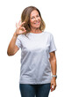 © Krakenimages.com - Middle age senior hispanic woman over isolated background smiling positive doing ok sign with hand and fingers. Successful expression.