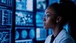© Bijac - african american female cybersecurity expert analyzing digital threats in high-tech environment with dramatic blue lighting, modern it security operations center