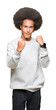 © Krakenimages.com - Young african american man with afro hair wearing sporty sweatshirt Ready to fight with fist defense gesture, angry and upset face, afraid of problem