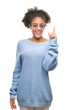 © Krakenimages.com - Young afro american woman wearing glasses over isolated background pointing finger up with successful idea. Exited and happy. Number one.