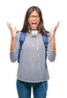 © Krakenimages.com - Young asian student woman wearing headphones and backpack over isolated background celebrating mad and crazy for success with arms raised and closed eyes screaming excited. Winner concept