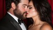 © Albert - A man and a woman in tuxedos kissing in front of a red curtain