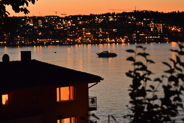 Wall Mural - House silhouette against evening city lights