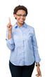 © Krakenimages.com - Young beautiful african american business woman over isolated background showing and pointing up with finger number one while smiling confident and happy.