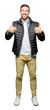 © Krakenimages.com - Handsome man wearing winter coat success sign doing positive gesture with hand, thumbs up smiling and happy. Looking at the camera with cheerful expression, winner gesture.