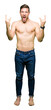 © Krakenimages.com - Handsome shirtless man showing nude chest shouting with crazy expression doing rock symbol with hands up. Music star. Heavy concept.