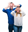 © Krakenimages.com - Young couple in love over isolated background doing ok gesture like binoculars sticking tongue out, eyes looking through fingers. Crazy expression.