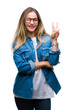 © Krakenimages.com - Young beautiful blonde woman wearing glasses over isolated background smiling with happy face winking at the camera doing victory sign. Number two.