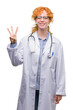 © Krakenimages.com - Young redhead woman wearing doctor uniform showing and pointing up with fingers number three while smiling confident and happy.