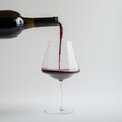 © Cheryl Rowley - pouring red wine into a glass on a white background