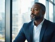 © Bijac - contemplative executive in tailored suit gazing through floor-to-ceiling windows of modern skyscraper office, strategic planning moment