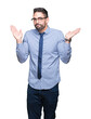 © Krakenimages.com - Young business man wearing glasses over isolated background clueless and confused expression with arms and hands raised. Doubt concept.