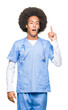 © Krakenimages.com - Young african american doctor man with afro hair pointing finger up with successful idea. Exited and happy. Number one.