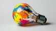 © Rauf - colourful light bulb on white background