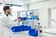 © EDER - Scientist organizing laboratory material on shelves in modern laboratory