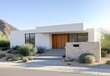© ma - A modern white stucco and stone home in the desert, surrounded by native plants, features a wood front door.