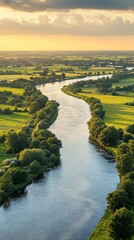 Wall Mural - River meandering through farmland at sunset