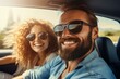 © nsit0108 - Young couple wearing sunglasses and smiling during a road trip in a car
